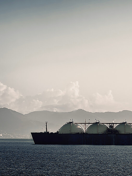 Large cargo ship loaded with oil tanks on the water