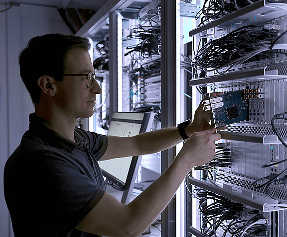 Man repairing connections, KVM Extender and IP KVM Switches on a server rack