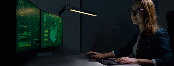 Woman works with a standard keyboard on two screens